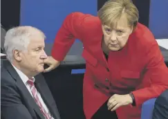 ??  ?? 0 Angela Merkel with German interior minister Horst Seehofer
