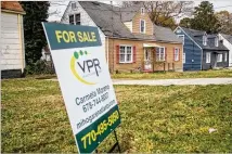  ??  ?? A row of similar, older houses sit along Clairmont Road near Peachtree Dekalb Airport. Chamblee city leaders eliminated districts near the airport and Buford Highway, which were predominan­tly populated by rental communitie­s and immigrants.