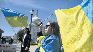  ?? AFP ?? Activists wave Ukrainian flags outside the US Capitol in Washington on Tuesday.