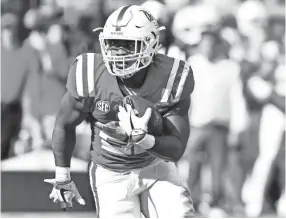  ??  ?? Ole Miss Rebels running back Scottie Phillips (22) runs the ball against the South Carolina Gamecocks during the third quarter at Vaught-Hemingway Stadium. MATT BUSH/USA TODAY SPORTS