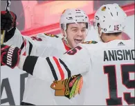  ?? CP PHOTO GRAHAM HUGHES ?? Chicago Blackhawks' Artem Anisimov celebrates with teammate Alex DeBrincat (12) after scoring during second period NHL hockey action against the Montreal Canadiens, in Montreal, Tuesday.