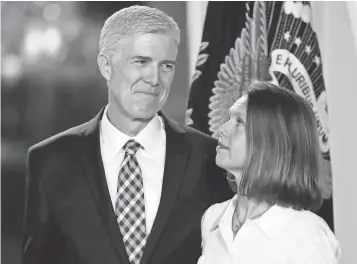  ?? CAROLYN KASTER, AP ?? Judge Neil Gorsuch and his wife, Louise, listen as his nomination is announced Jan. 31.