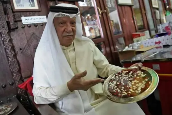  ?? ?? PERFECT PUDDINGS: Mohammed Gharib, 70, who runs one of Bahrain's oldest confection­ary shops says the kingdom is a pioneer of making sweets in the Gulf region.