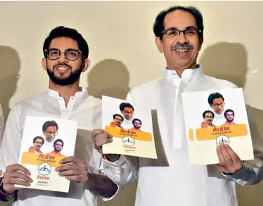  ?? KUNAL PATIL/ GETTY IMAGES ?? TRUMP CARD
Shiv Sena chief Uddhav Thackeray, along with son Aaditya, releasing the party manifesto, Oct. 12