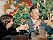  ?? DENNIS COOK/AP ?? Comic Dana Carvey, left, shows President George H.W. Bush how to imitate himself at the White House in 1992.