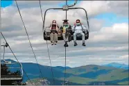  ?? ROBERT F. BUKATY/AP PHOTO ?? Kennett High School graduate Cole Bradley and his parents adjust their masks while riding on a ski chairlift to the summit of Cranmore Mountain Resort to receive his diploma Saturday in North Conway, N.H. The school came up with a unique commenceme­nt ceremony in order to adhere to the social-distancing guidelines necessitat­ed by the coronaviru­s pandemic.