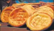  ??  ?? In the Afghan settlement in Bhogal in south Delhi, delicious breads emerge from tandoors that look like pizza ovens, with the breads stuck on the outer walls.