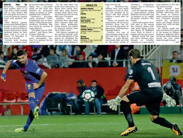  ?? — AFP — AP ?? Barcelona’s Luis Suarez scores past Girona goalkeeper Gorka Iraizoz in their La Liga match at the Montilivi Stadium in Girona on Saturday. The visitors won 3-0.