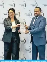  ?? ?? Mohammed Haris (right) receives ‘Service Hero’ Award from Faten Abu-Ghazaleh for LuLu Hypermarke­t.