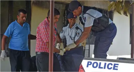  ?? Photo: Waisea Nasokia ?? Police carrying a body bag onto the Police truck at Navakai, Nadi on March 16, 2019.