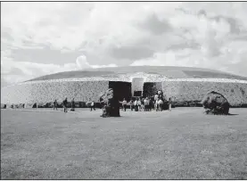  ?? Rick Steves’ Europe/PAT O’CONNOR ?? Newgrange’s facade is a mosaic of white quartz and dark granite. Above the doorway is a square window, which plays a key role in illuminati­ng the sacred chamber during the winter solstice.