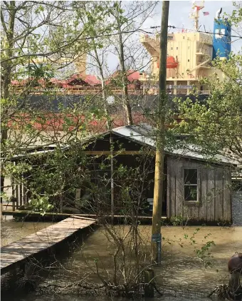  ??  ?? A ship passing a house on the batture, New Orleans, 2016