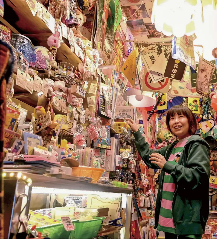  ?? Yomiuri Shimbun photos ?? Hitomi Ando stands in her shop filled with merchandis­e in Nerima Ward, Tokyo.