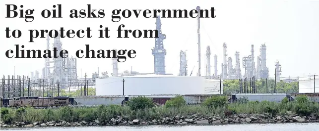  ??  ?? Storage tanks at a refinery along the waterway seen on Thursday, July 26, in Port Arthur, Texas. The oil industry wants the government to help protect some of its facilities on the Texas Gulf Coast against the effects of global warming.