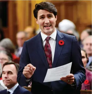  ?? SEAN KILPATRICK/THE CANADIAN PRESS ?? Prime Minister Justin Trudeau says Canada still wants tariffs lifted before the new NAFTA goes into effect and will work with whomever Americans elect in the key midterm elections.