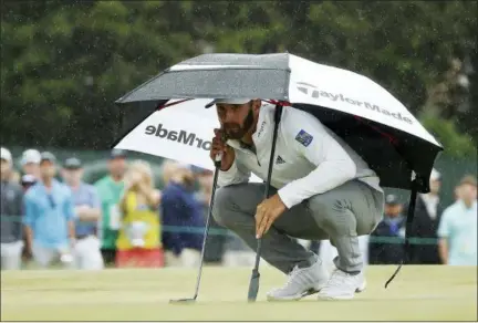  ?? CAROLYN KASTER — THE ASSOCIATED PRESS ?? Dustin Johnson lines up a putt on the 15th green during the second round of the U.S. Open Golf Championsh­ip, Friday in Southampto­n, N.Y.