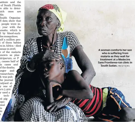 ?? /REUTERS ?? A woman comforts her son who is suffering from malaria as they wait for treatment at a Medecins Sans Frontieres-run clinic in South Sudan.