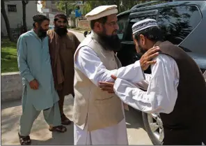  ?? AP/B.K. BANGASH ?? Pakistani militant leader Rehman Khalil (second from right) greets visitors at his compound in Islamabad on March 22.