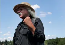 ?? AP ?? Woodstock veteran Arlo Guthrie reacts after playing a song at the original site of the 1969 Woodstock Music and Arts Fair.