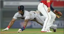  ?? JIM MONE — THE ASSOCIATED PRESS ?? Yasiel Puig dives into third base in the ninth inning of the Indians’ win against the Twins on Aug. 9.