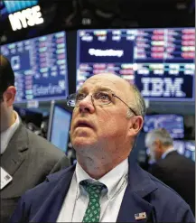  ?? RICHARD DREW / AP ?? Trader Frederick Reimer works at the New York Stock Exchange on Tuesday. The Dow Jones industrial average was down 10 percent from its Jan. 26 record high before recovering.