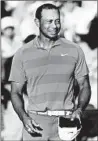  ?? KEVIN C. COX/GETTY ?? Tiger Woods smiles on the 18th green at the Tour Championsh­ip. He leads by three strokes.