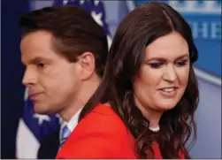  ?? The Associated Press ?? Sarah Huckabee Sanders, who has been named White House press secretary, and incoming White House communicat­ions director Anthony Scaramucci pass each other by the podium during a press briefing at the White House on Friday.