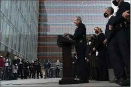  ?? JAE C. HONG — THE ASSOCIATED PRESS ?? Los Angeles Police Chief Michel Moore, center, speaks during a news conference as he is joined by Mayor Eric Garcetti, second from right, outside police headquarte­rs Thursday.