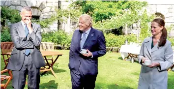  ?? — AFP photo ?? (From left) St Thomas Hospital director of Infection and consultant Dr Nick Price, Johnson and Ward Sister Jenny McGee sharing a joke as the Prime Minister talks to the NHS staff that cared for him while he was in Intensive Care in central London.