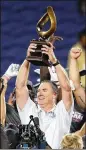  ?? STEPHEN ?? Coach Shawn Elliott, with the Cure Bowl trophy, led GSU to a 7-5 finish, the most wins in school history.