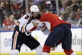  ?? LYNNE SLADKY — THE ASSOCIATED PRESS ?? Edmonton’s Jujhar Khaira (16) and Florida’s Josh Brown fight during the second period on Saturday, in Sunrise, Fla.