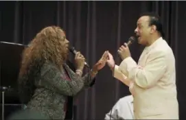  ?? CARLOS OSORIO — THE ASSOCIATED PRESS ?? In this photo, singers Mark Scott of The Miracles and Joan Belgrave, left, perform in Detroit.