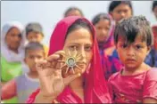  ?? PTI ?? A woman shows a part of a mortar shell, allegedly fired from the Pakistani side, at RS Pura in Jammu on Friday.