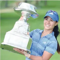  ?? — USA Today Sports ?? Danielle Kang poses with her trophy after winning the Women’s PGA Championsh­ip at Olympia Fields Country Club.