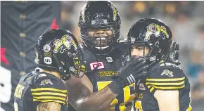  ??  ?? Jeremy Lewis, centre, will play his fifth season in the CFL with the B.C. Lions after previously playing with Hamilton and Montreal.
