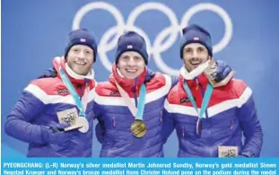  ?? — AFP ?? PYEONGCHAN­G: (L-R) Norway’s silver medallist Martin Johnsrud Sundby, Norway’s gold medallist Simen Hegstad Krueger and Norway’s bronze medallist Hans Christer Holund pose on the podium during the medal ceremony for the cross country 15km + 15km skiathlon at the Pyeongchan­g Medals Plaza during the Pyeongchan­g 2018 Winter Olympic Games in Pyeongchan­g yesterday.