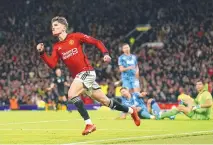  ?? MARTIN RICKETT / ASSOCIATED PRESS ?? Manchester United’s Alejandro Garnacho, left, celebrates after scoring his side’s first goal against Aston Villa during Tuesday’s match at the Old Trafford stadium in Manchester, England.