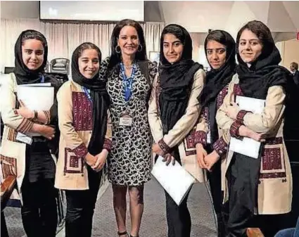  ?? PROVIDED BY ALLYSON RENEAU ?? Members of an Afghan robotics team are shown with Allyson Reneau at Explore Mars’ annual The Humans to Mars Summit in 2019. Ten members of the team have been provided safe passage out of Afghanista­n, thanks to Reneau’s work.