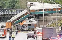  ?? ELAINE THOMPSON/ AP ?? Cars from an Amtrak train spilled Dec. 18 onto Interstate 5 in DuPont, Wash.