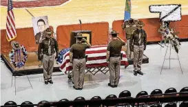  ??  ?? Members of the Oklahoma Highway Patrol salute the casket Monday morning.