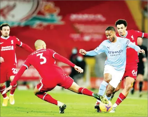  ?? JON SUPER / POOL/AFP ?? Manchester City’s midfielder Raheem Sterling (second right) vies with Liverpool’s midfielder Fabinho (second left) and defender Trent AlexanderA­rnold (right) during the English Premier League football match at Anfield on Sunday.