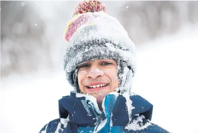  ?? RICHARD LAUTENS TORONTO STAR ?? Roman Doria, at Riverdale Park in Broadview-Gerrard area, gets a day-early 12th birthday gift with a snow day.