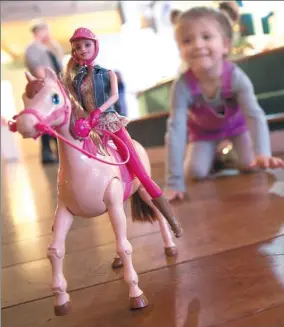  ?? BLOOMBERG ?? A child plays with a Barbie Saddle ’N Ride Horse and Doll, manufactur­ed by Mattel Inc, at the Toy Retailers Associatio­n DreamToys 2015 event in London.