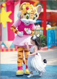  ??  ?? A tiger character interacts with a visitor at the Chimelong Paradise in Guangzhou, the capital of Guangdong province, on Sept 20.