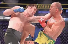  ?? ED MULHOLLAND, USA TODAY SPORTS ?? Chael Sonnen, left, earned a decision win against hated rival Wanderlei Silva, right, in the headline match Saturday.