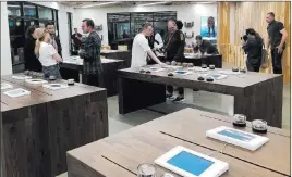  ?? Todd Prince ?? Las Vegas Review-journal Medmen employees explain the products on sale to customers with the help of tablets on wooden tables at the store on Paradise Road on Thursday.