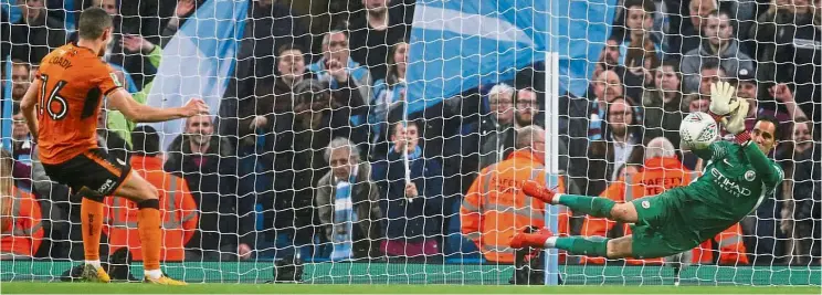  ??  ?? Manchester City’s Claudio Bravo saving a penalty from Wolverhamp­ton Wanderers’ Conor Coady in a penalty shootout during the English League Cup fourth-round clash at the Etihad on Tuesday. City won 4-1. — Reuters Right place, right time: