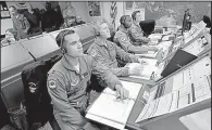  ?? Los Angeles Times/AL SEIB ?? Air Force officers at the Vandenberg Air Force Base launch center prepare for a test flight of a Minuteman III missile that was pulled out of its silo in Montana and set up in a similar compound at the California base.