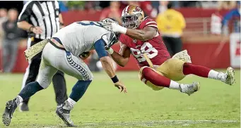  ?? GETTY IMAGES ?? San Francisco 49ers defensive end Ronald Blair tackles Seattle quarterbac­k Russell Wilson during their November match-up, which Seattle won in overtime.