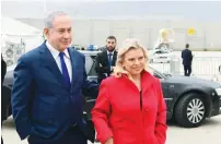 ?? (Amos Ben Gershom/GPO) ?? PRIME MINISTER Benjamin Netanyahu and his wife, Sara, walk on the tarmac at Ben-Gurion Airport yesterday prior to taking off for Davos.